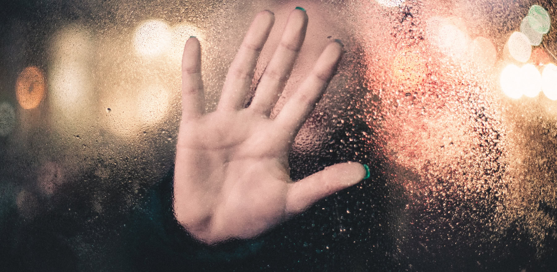 Hand placed on a window with all the visible palm lines and mounts